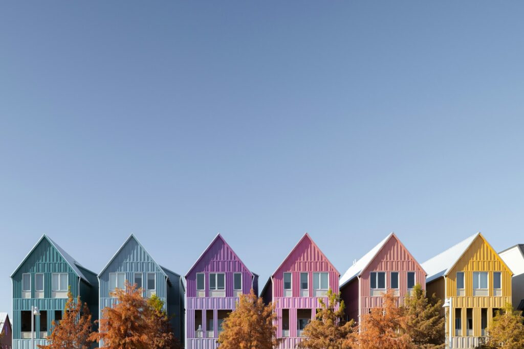 Colorful houses line a bright blue sky.